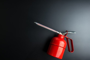 Red spray gun isolated over black background.