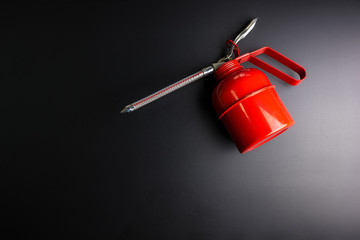 Red spray gun isolated over black background.