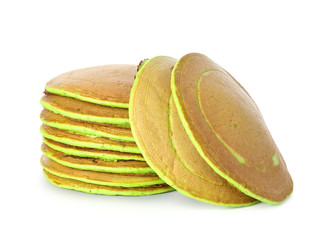 Tasty green pancakes on white background