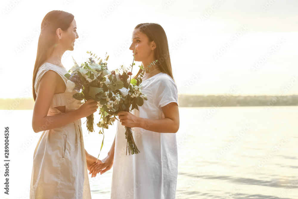 Sticker Beautiful lesbian couple on their wedding day near river