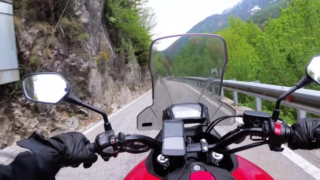 Motorcyclist on Motorbike Rides on a Beautiful Landscape Mountain Road in Italy