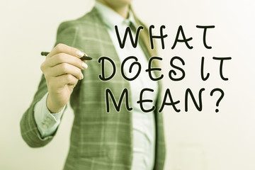 Writing note showing What Does It Mean question. Business concept for intended to communicate unclear statement Business woman pointing in empty space with pen