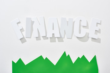 top view of finance inscription with green statistic graph on white background