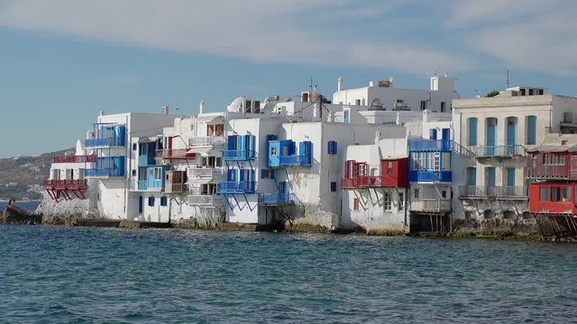 Panoramic view of Little Venice in Mykonos town. Greece. Beautiful harbor at Aegean sea, Cyctades islands. Amazing landscape with colorful buildings, Tourists enjoying restaurants along promenade