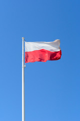 Fototapeta na wymiar Poland national flag on blue sky background