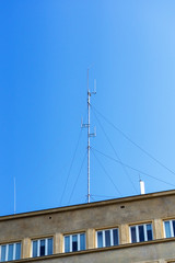 Communication antennas on the roof of a multi-storey building.