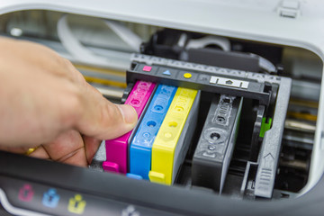 Technicians are install setup the ink cartridge or inkjet cartridge is a component of an inkjet...