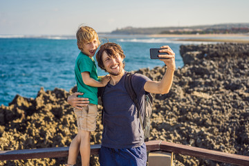 Father and son travelers on amazing Nusadua, Waterbloom Fountain, Bali Island Indonesia. Traveling with kids concept