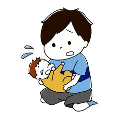 泣いている赤ちゃんを抱っこする男の子