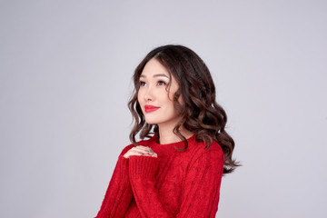 Portrait of beauty winter asian girl in red knitted woolen dress. Christmas Holiday.
