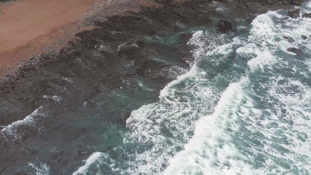 Aerial overhead shot of Ocean Waves crushing on the Beach in Biarritz Resort - Basque Country South West of France