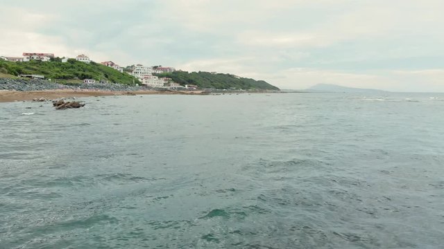 Aerial Shot of Seagulls flying over Ocean in front of Guethary Beach Resort - Basque Country South West of France