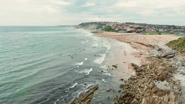 Aerial Shot of Ocean Shore with many Surfers, Swimmers and People on the Beach near Biarritz Beach Resort - Basque Country South West of France