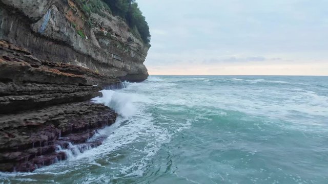 Aerial shot of Big Waves crushing on Cliff in Biarritz Beach Resort at sunset - Basque Country South West of France