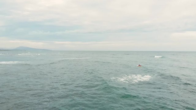 Aerial Short orbiting around a Surfer alone in the Ocean in Guethary Beach Resort - Basque Country South West of France