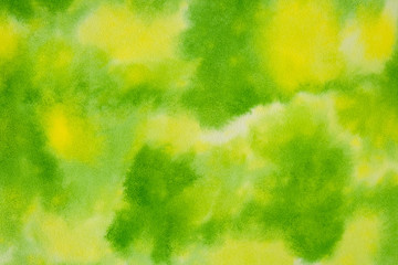 Abstract green watercolor background, bright, contrast splashes, drops, smudges. Artistic background with paper texture.