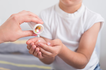 Doctor prescribes pills for a little boy. Treating a child at home
