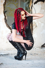 Beautiful young woman with piercing, dreads and stylish make-up.  Woman cyberpunk.