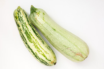 Summer harvest of vegetables concept. Zucchini on a light white background.