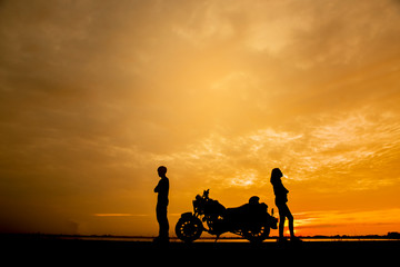 Naklejka na ściany i meble Break Up,Bad relationship,Anger,unhappy, concept.Silhouette of anger of couples love who are quarreling (argument) and standing back to back with Motorcycle against beautiful sunset background in Thai