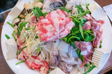 Set of hot pot with vegetables morning glory, mushroom, bacon, seafood shrimp, squid, shellfish, fish, ball, tofu delicious Asian cuisine Vietnamese traditional food
