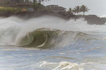 massive stormy wave breaking at waimea bay in hawaii