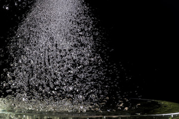 a lot of falling drops on a black background, like heavy rain