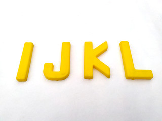 yellow plastic alphabet letters isolated on white background