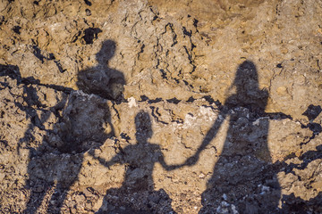 Shadow of a family on the rocks