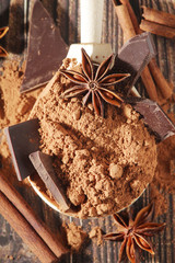 Cocoa powder and a bar of dark chocolate