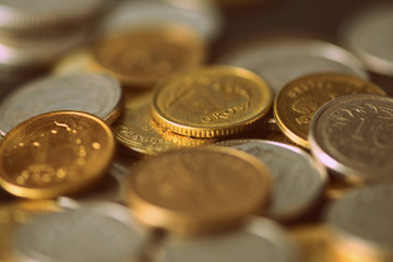 Polish coins scattered on a dark background close up. Retro style