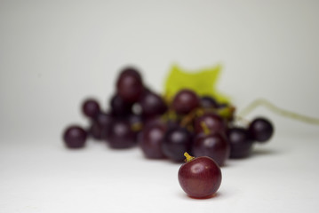 Grape on blurred grapes and white background
