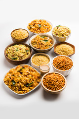 Group of Cornflake and Thick Poha Chivda or Chiwda and Chatpata Masala chana and fried crispy Moong Dal, served in a bowl. selective focus