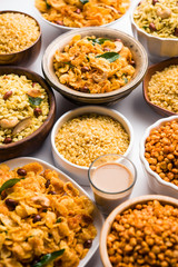 Group of Cornflake and Thick Poha Chivda or Chiwda and Chatpata Masala chana and fried crispy Moong Dal, served in a bowl. selective focus