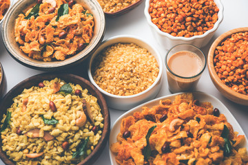 Group of Cornflake and Thick Poha Chivda or Chiwda and Chatpata Masala chana and fried crispy Moong Dal, served in a bowl. selective focus