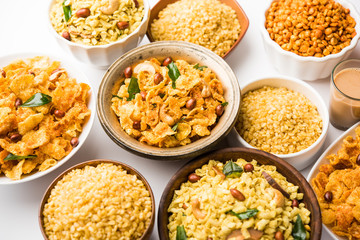 Group of Cornflake and Thick Poha Chivda or Chiwda and Chatpata Masala chana and fried crispy Moong Dal, served in a bowl. selective focus