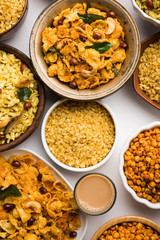 Group of Cornflake and Thick Poha Chivda or Chiwda and Chatpata Masala chana and fried crispy Moong Dal, served in a bowl. selective focus