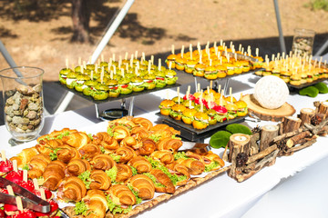 a tray with burgers and cold dishes for guests. Theme is catering.