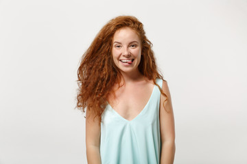 Young funny smiling redhead woman girl in casual light clothes posing isolated on white wall background, studio portrait. People sincere emotions lifestyle concept. Mock up copy space. Showing tongue.