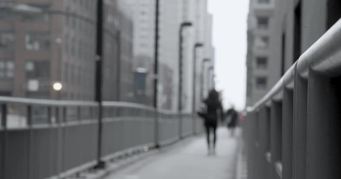 Woman walking in city overpass in winter