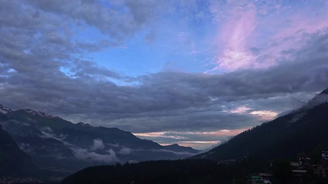 A panaromic shot of a valley in manali during sunset .