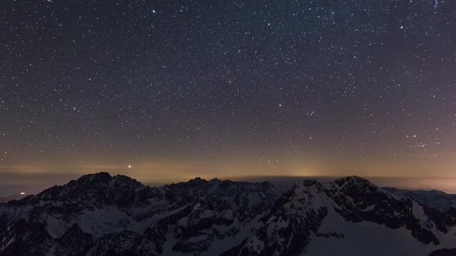 Timelapse is showing a view of the night sky from Lomnicky Peak in April over Tatra Mountains.