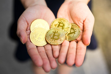 Selective of focus with Businesswoman holding the bitcoin gold coin,Digitall symbol of a new virtual currency concept.