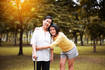 Senior asian older mother happy with hand daughter take care and support at outdoor