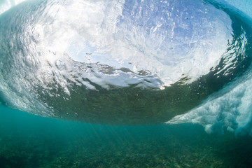 under water scene of a crashing wave close up