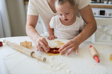 girl with Down syndrome and family in the kitchen