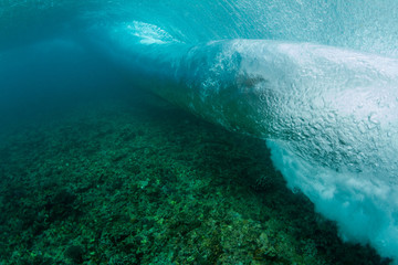 under water wave crashing on a shallow coral reef © Ryan