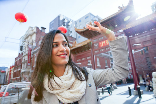 Woman Waving to Friend in Chinatown
