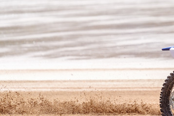 Fototapeta na wymiar Blurred Sand From A Racing Motorbike