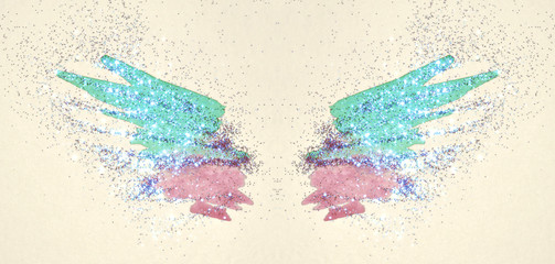 Blue glitter on abstract pink and blue watercolor wings in vintage nostalgic colors.